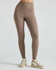 Model wears sustainable light brown nylon rib leggings