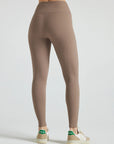 Model wears sustainable light brown nylon rib leggings