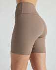 Model wears sustainable light brown nylon rib biker shorts