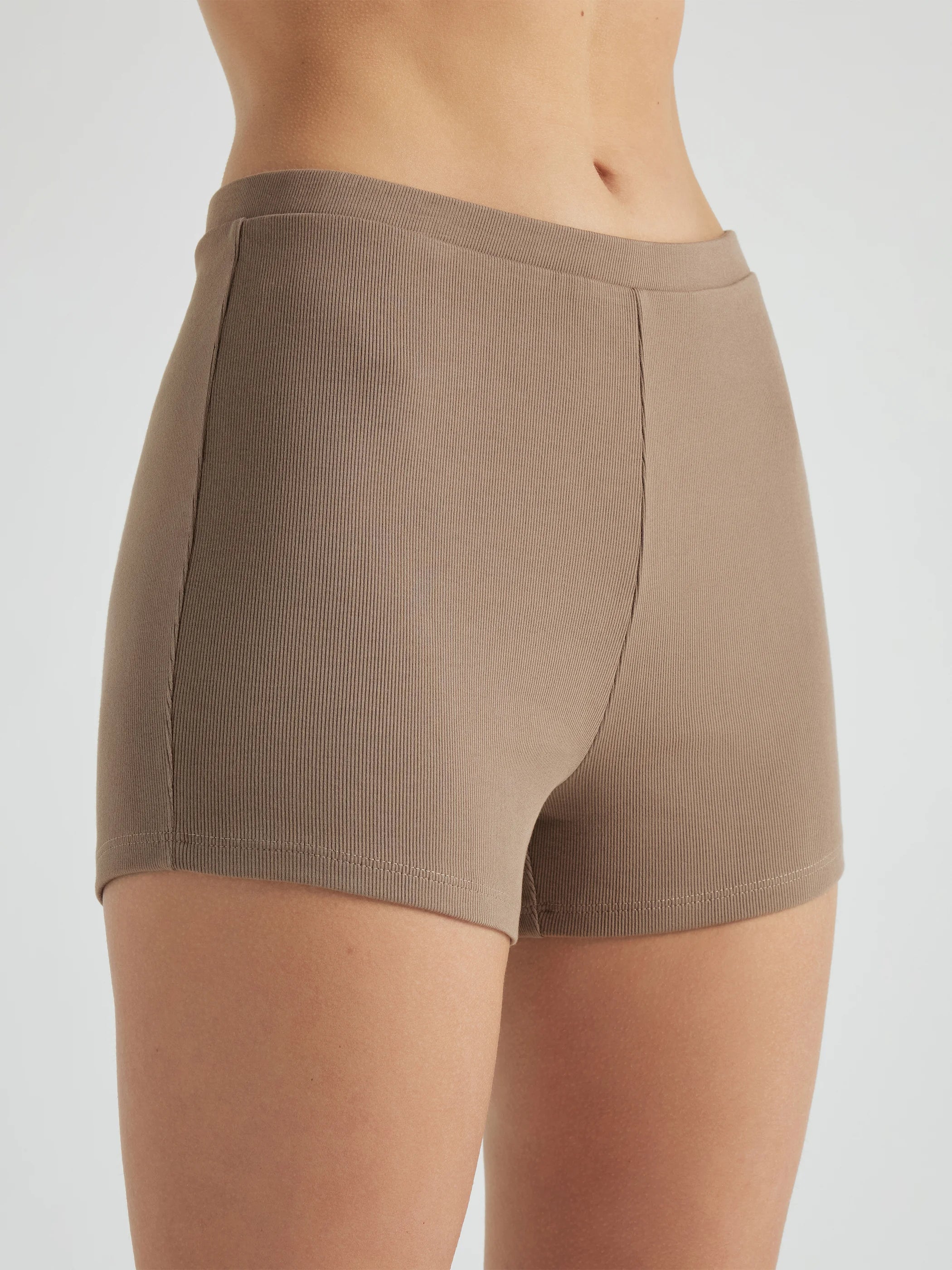 model wears light brown 3 inch inseam rib shorts
