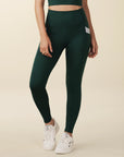 Model wears full length crossover deep pocket leggings in green and light blue
