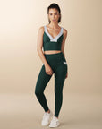 Model wears full length crossover deep pocket leggings in green and light blue