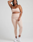model poses in ballet-pink leggings with corset boning