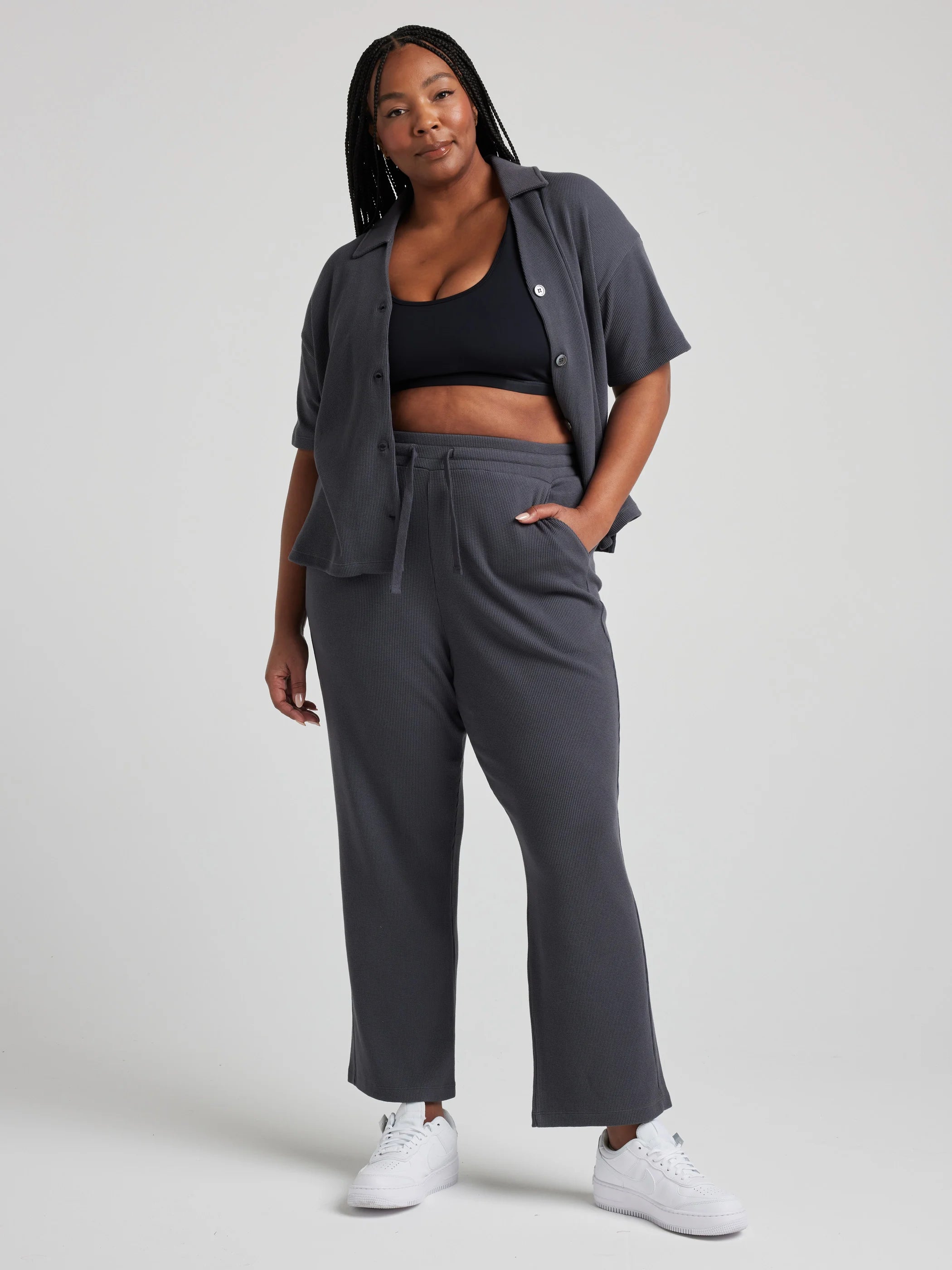 model wears relaxed waffle knit pants in charcoal