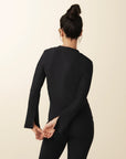 model wears cozy v-neck top with slit in black