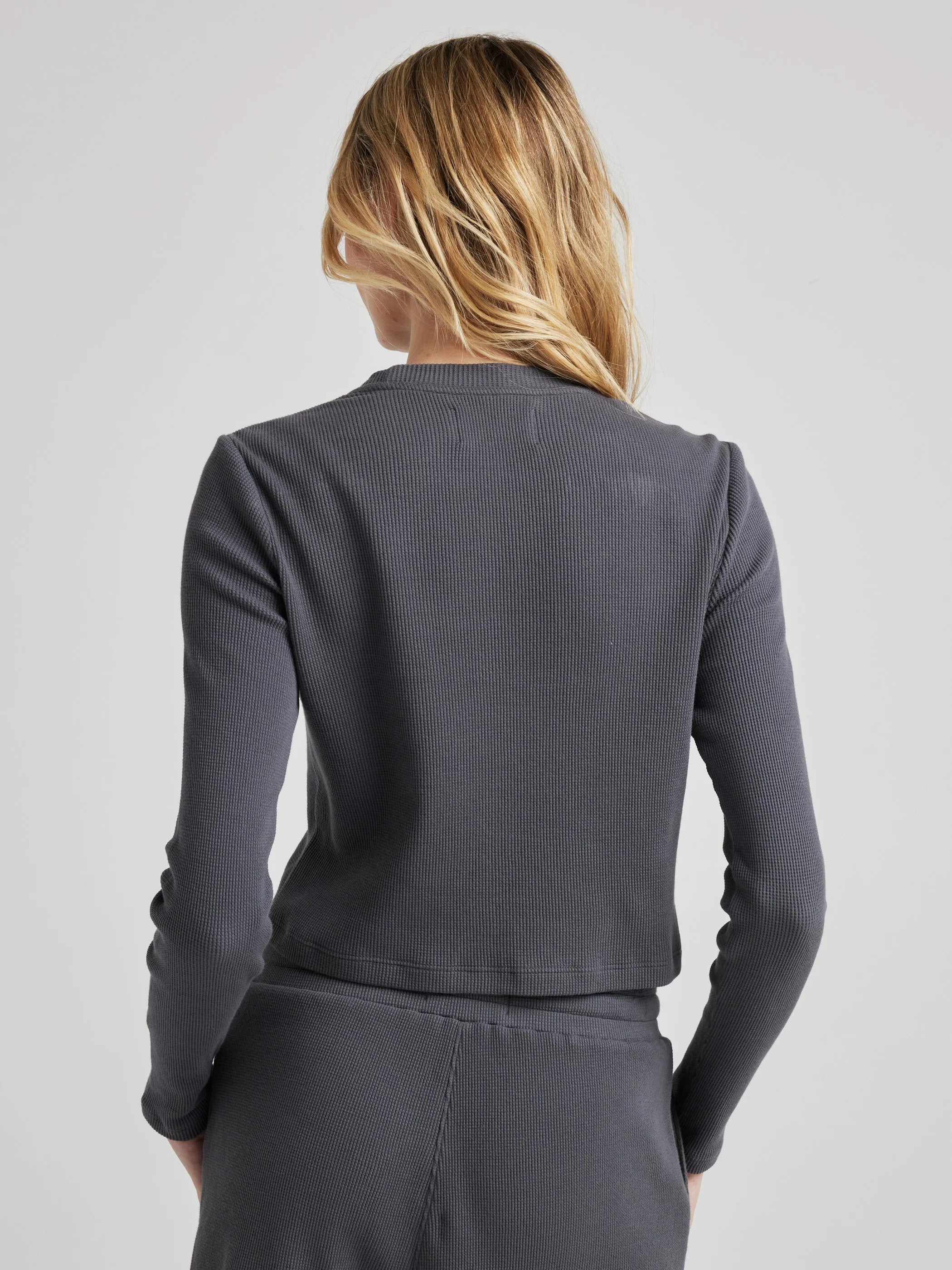 model wears organic thermal long sleeve in grey