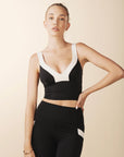 model wears cutest black and cream colorblock sports bra with adjustable straps