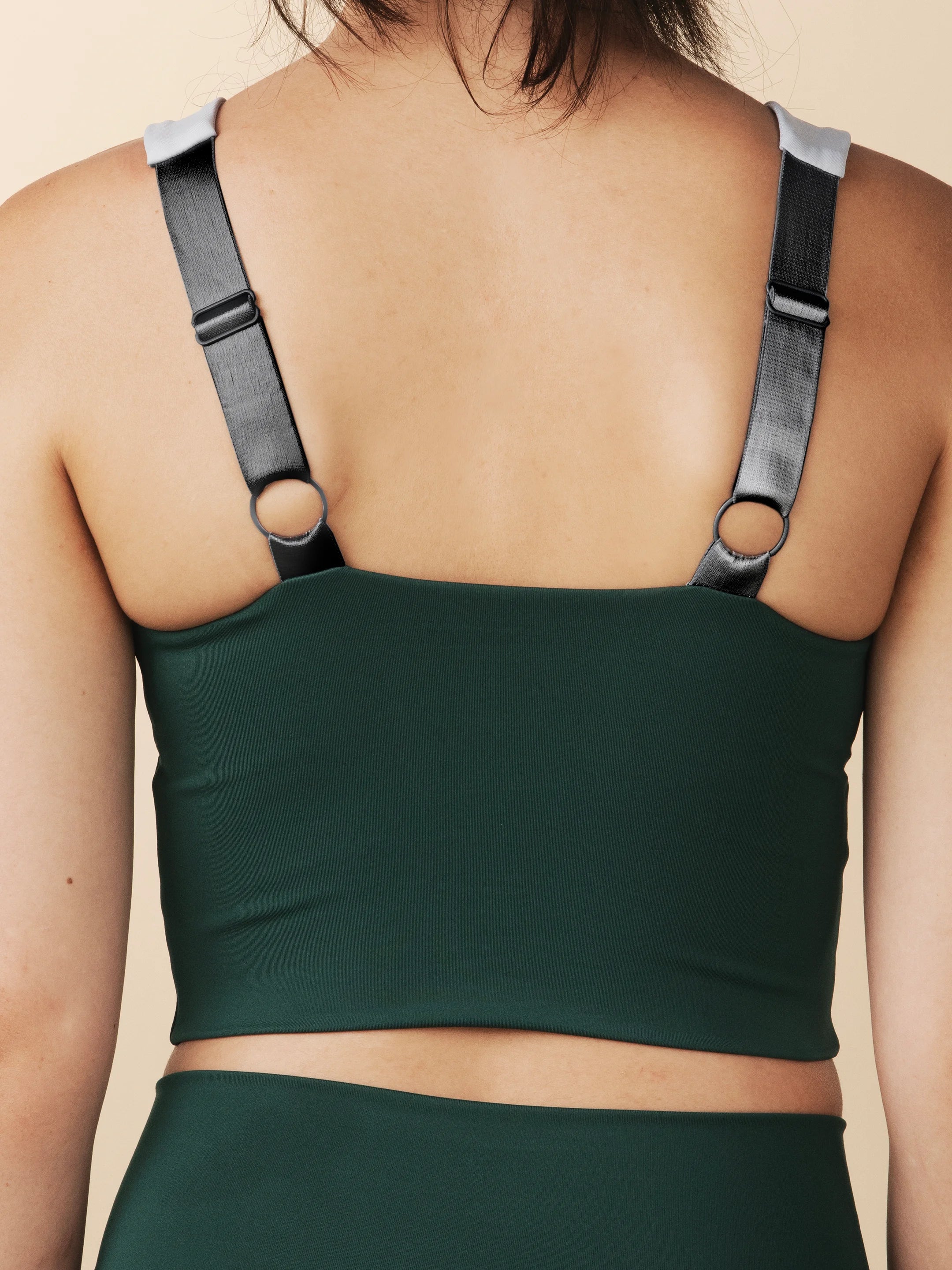 model wears cutest green and blue  colorblock sports bra with adjustable straps