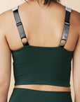 model wears cutest green and blue  colorblock sports bra with adjustable straps